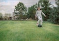 Cute little girl playing football with soccer ball on green lawn in backyard of house. Child kicking soccer ball on Royalty Free Stock Photo