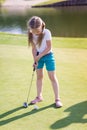 Cute little girl playing golf on a field Royalty Free Stock Photo