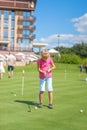 Cute little girl playing golf on a field outdoor Royalty Free Stock Photo