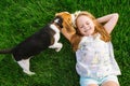 Cute little girl is playing with her dog in the green park Royalty Free Stock Photo