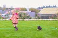 Cute little girl playing with her puppy in the yard Royalty Free Stock Photo