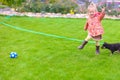 Cute little girl playing with her puppy in the yard Royalty Free Stock Photo