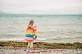 Cute little girl playing by the lake on a windy day Royalty Free Stock Photo