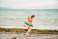 Cute little girl playing by the lake on a windy day Royalty Free Stock Photo