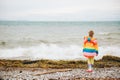 Cute little girl playing by the lake on a windy day Royalty Free Stock Photo