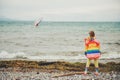 Cute little girl playing by the lake on a windy day Royalty Free Stock Photo