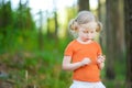 Cute little girl playing `loves me? loves me not?` daisy petal game Royalty Free Stock Photo