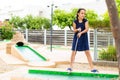 Cute little girl playing mini golf in a park Royalty Free Stock Photo