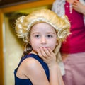 Cute little girl playing piano, dressing in retro Mozart periwig Royalty Free Stock Photo