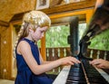 Cute little girl playing piano, dressing in retro Mozart periwig Royalty Free Stock Photo