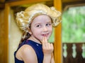 Cute little girl playing piano, dressing in retro Mozart periwig Royalty Free Stock Photo