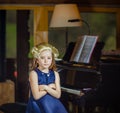 Cute little girl playing piano, dressing in retro Mozart periwig Royalty Free Stock Photo