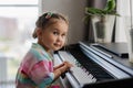 Cute little girl playing piano at a music school Royalty Free Stock Photo