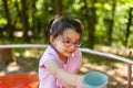 Cute little girl playing on the playground in the park. Outdoor photo Royalty Free Stock Photo