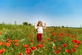 Cute little girl playing in red poppies field summer day, beauty Royalty Free Stock Photo