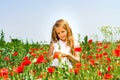 Cute little girl playing in red poppies field summer day, beauty Royalty Free Stock Photo