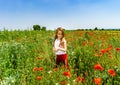 Cute little girl playing in red poppies field summer day, beauty Royalty Free Stock Photo