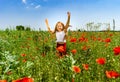 Cute little girl playing in red poppies field summer day, beauty Royalty Free Stock Photo