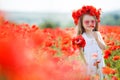 Cute little girl playing in red poppies field summer day beauty and happiness France