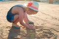 Cute little girl playing with sand on the beach Royalty Free Stock Photo