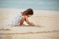 Cute little girl playing with sand on the beach in Dubai Royalty Free Stock Photo