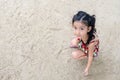 Cute little girl playing with sand