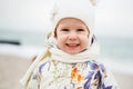 Cute little girl playing on the sandy beach. Happy child wearing Royalty Free Stock Photo