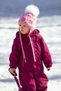 Cute little girl playing with shovel on a cold sunny winter day Royalty Free Stock Photo