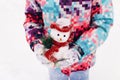 Cute little girl playing with snowman toy in winter park. Merry christmas concept. Outdoor winter activities for kids Royalty Free Stock Photo