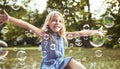 Cute little girl playing soap bubbles Royalty Free Stock Photo