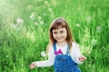 Cute little girl playing with soap bubbles on the green lawn outdoor, happy childhood concept, child having fun Royalty Free Stock Photo