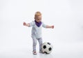 Cute little girl playing with soccer ball. Studio shot. Royalty Free Stock Photo