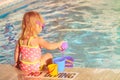 Cute little girl playing in swimming pool at beach Royalty Free Stock Photo