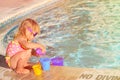 Cute little girl playing in swimming pool at beach Royalty Free Stock Photo