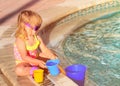 Cute little girl playing in swimming pool at beach Royalty Free Stock Photo