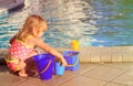 Cute little girl playing in swimming pool at beach Royalty Free Stock Photo