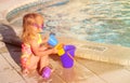 Cute little girl playing in swimming pool at beach Royalty Free Stock Photo