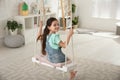 Cute little girl playing on swing Royalty Free Stock Photo