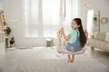 Cute little girl playing on swing at home Royalty Free Stock Photo