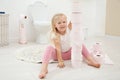 Cute little girl playing with toilet paper Royalty Free Stock Photo