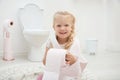 Cute little girl playing with toilet paper Royalty Free Stock Photo