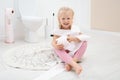 Cute little girl playing with toilet paper Royalty Free Stock Photo