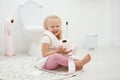 Cute little girl playing with toilet paper Royalty Free Stock Photo