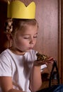 Cute little girl playing with a toy frog, pretending to be a princess Royalty Free Stock Photo