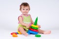 Cute little girl playing with a toy pyramid Royalty Free Stock Photo