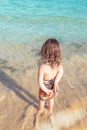 cute little girl playing on a tropical beach