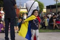 Cute little girl playing with Venezuelan flag at protest