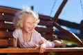 Cute little girl playing on wooden chain s Royalty Free Stock Photo