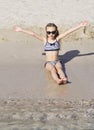 Cute little girl plays on the beach. Royalty Free Stock Photo