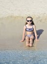 Cute little girl plays on the beach. Royalty Free Stock Photo